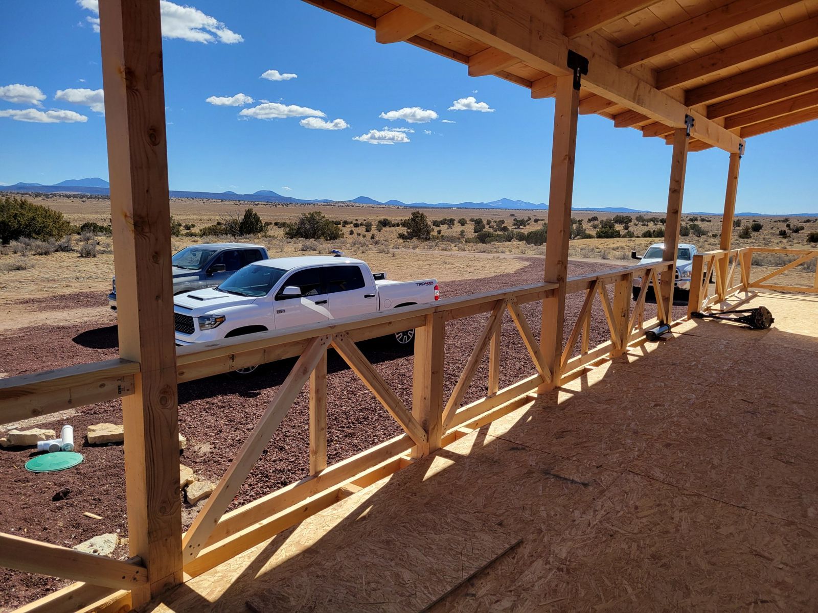 Grand Canyon Cabin deck: timber railing with X-brace panels overlooking the high desert