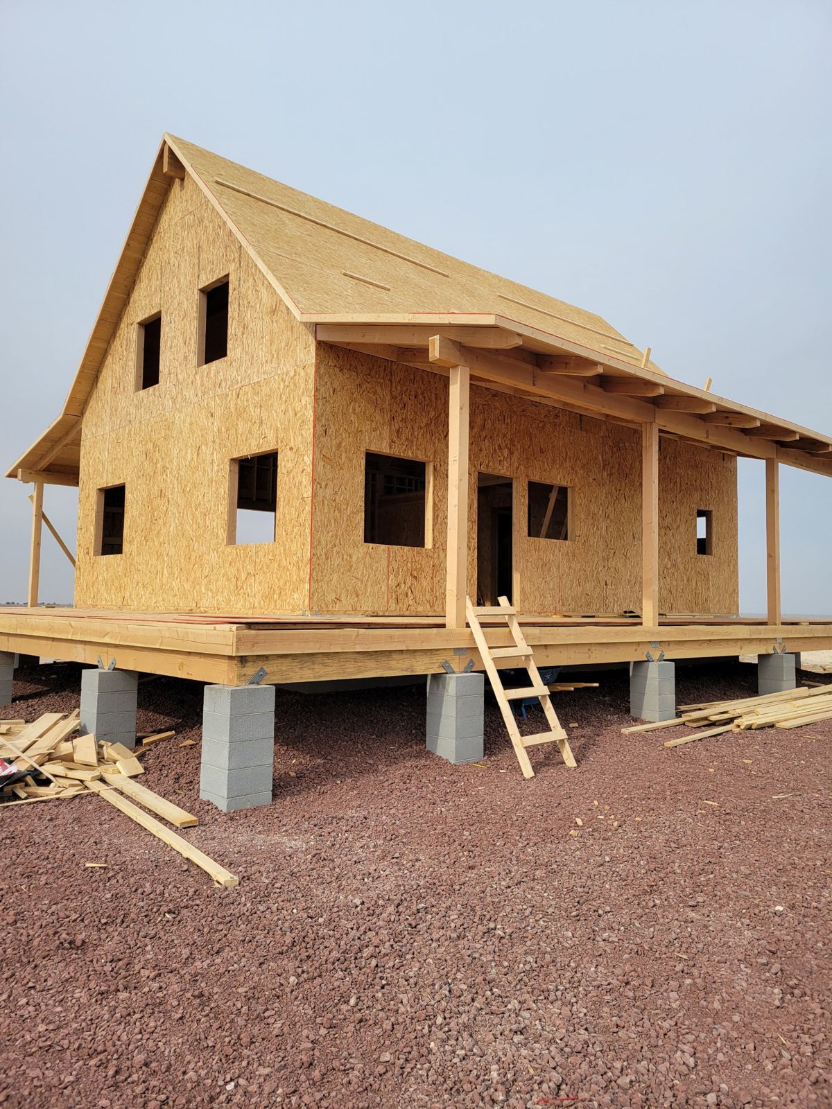 Grand Canyon Cabin during framing: sheathed walls and roof with timber porch on block piers