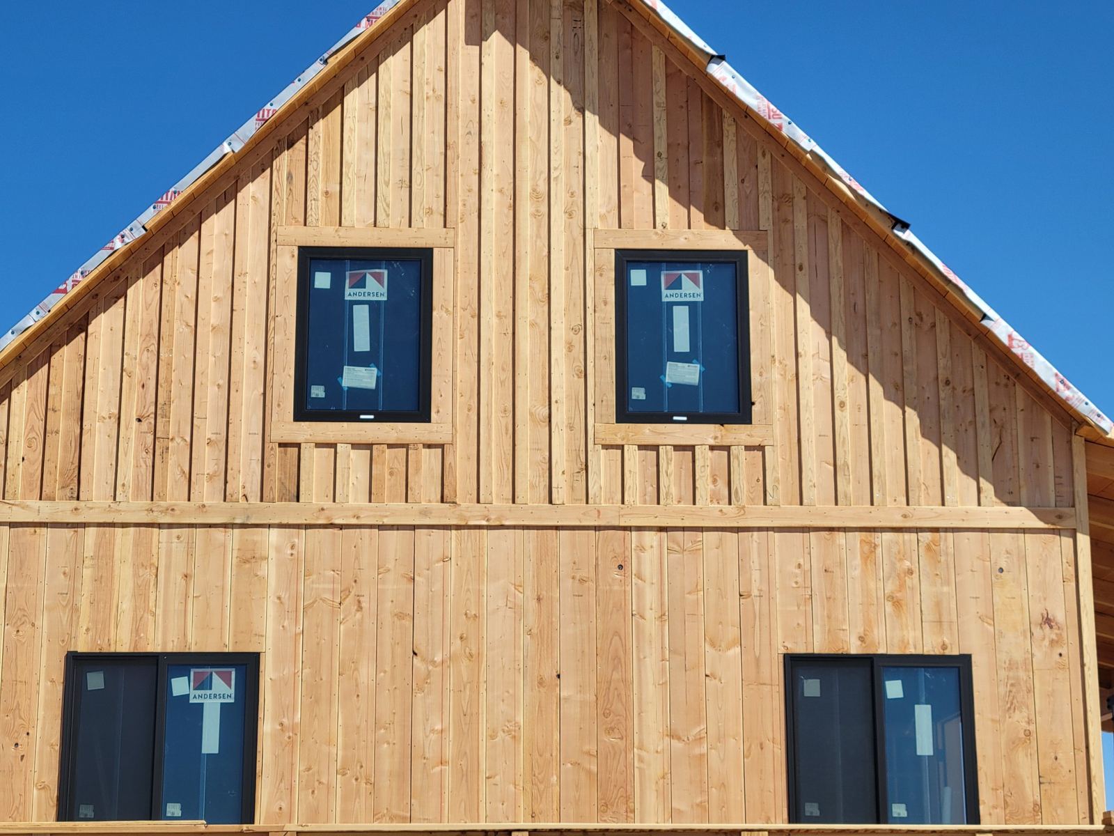 Grand Canyon Cabin gable end: board-and-batten siding with new Andersen windows