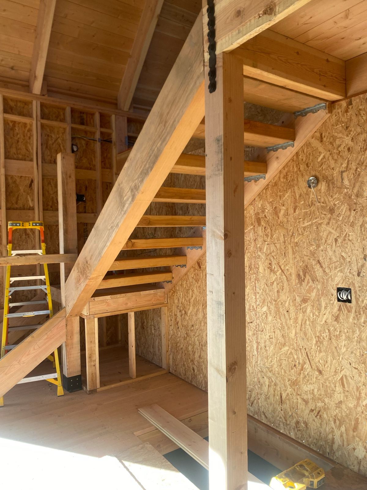 Grand Canyon Cabin interior: open-tread timber staircase on heavy stringers below the loft