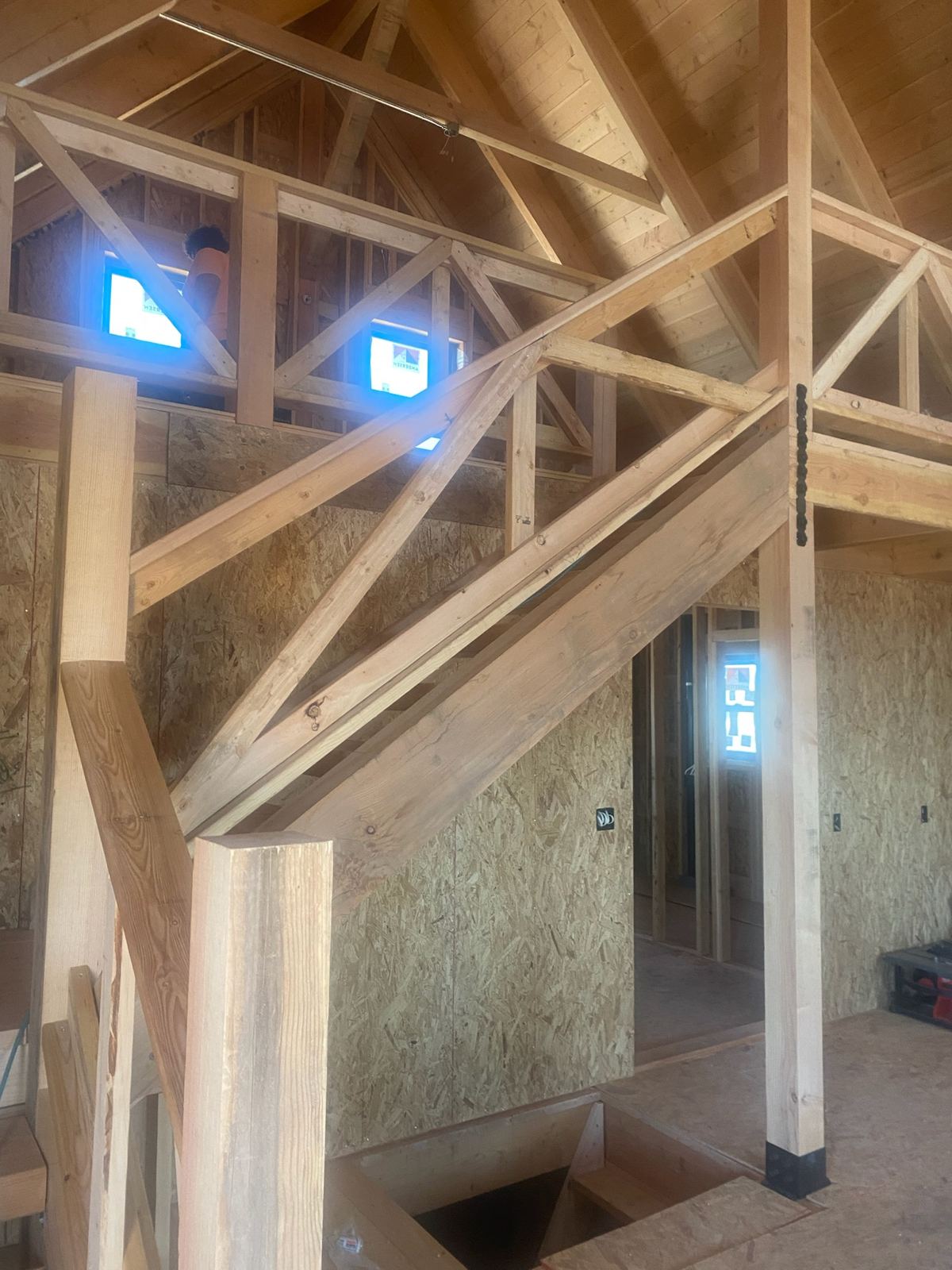 Grand Canyon Cabin interior: staircase and loft railing with timber X-bracing under the vaulted ceiling