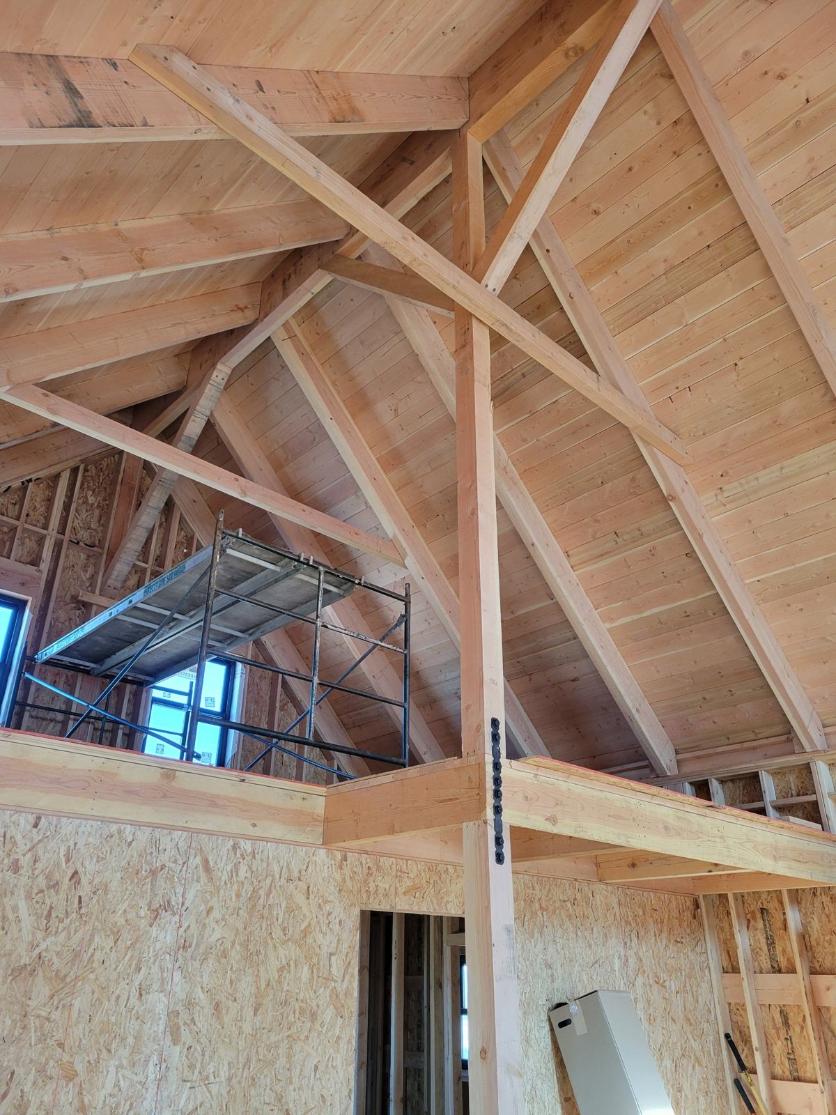 Grand Canyon Cabin interior: timber post and braces rising past the loft to the vaulted ceiling