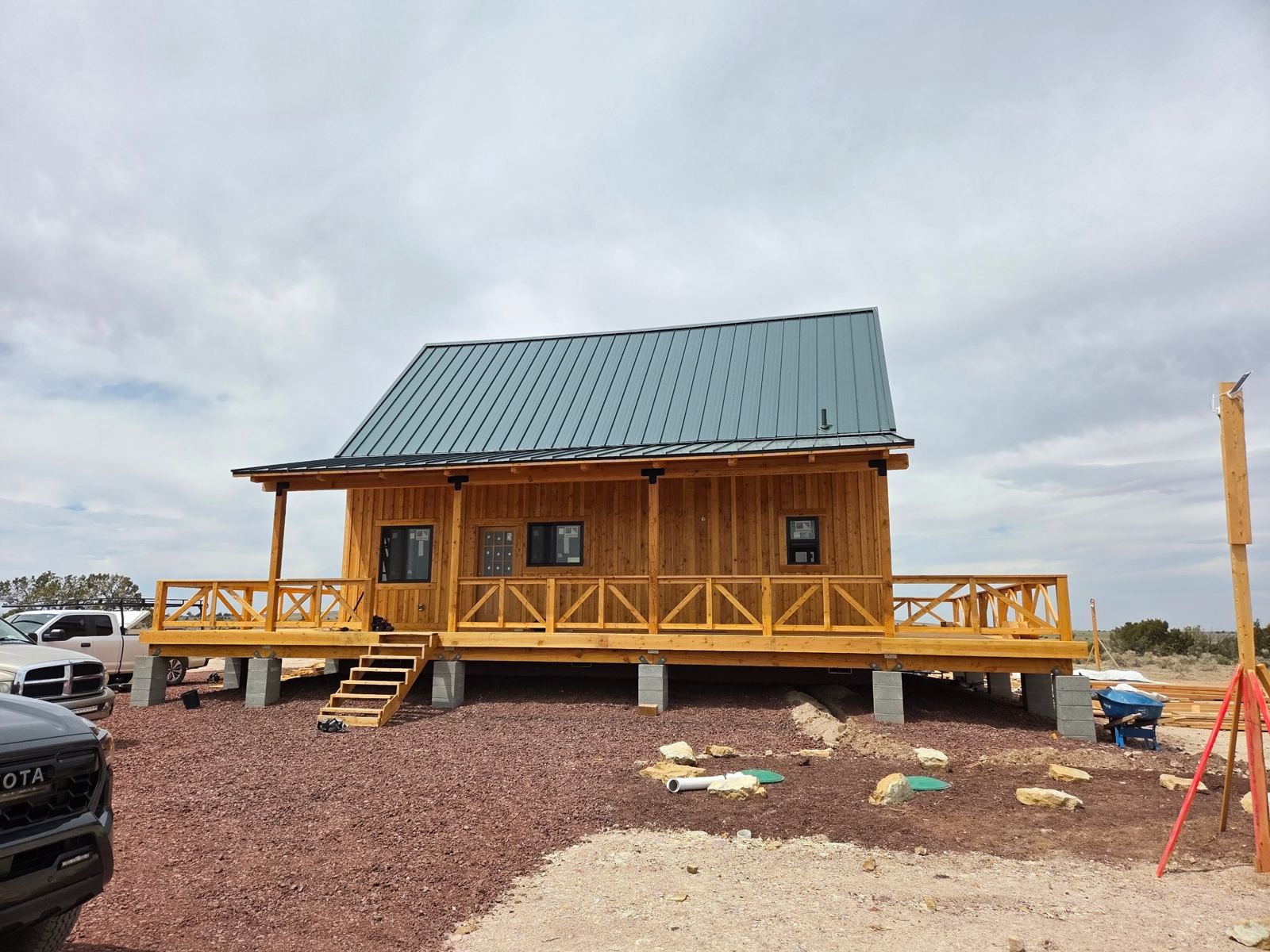 Grand Canyon Cabin nearly complete: green metal roof, stained siding and wraparound deck