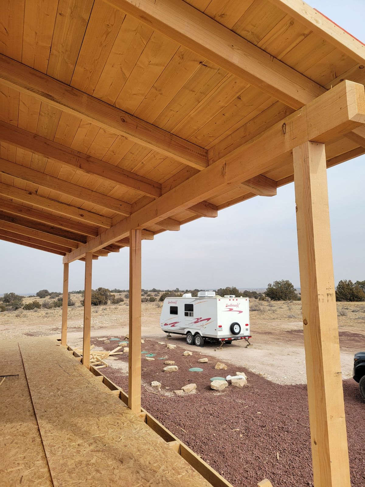 Grand Canyon Cabin porch: heavy timber posts and beams under a tongue-and-groove porch ceiling