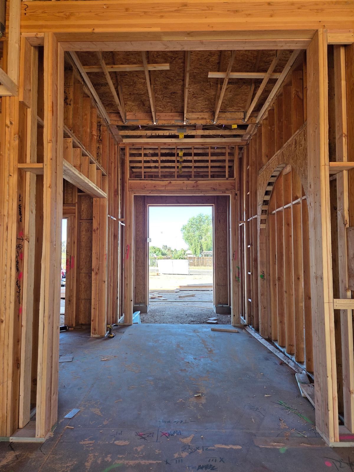 Mescal Residence interior: framed hallway with arched opening leading to the entry