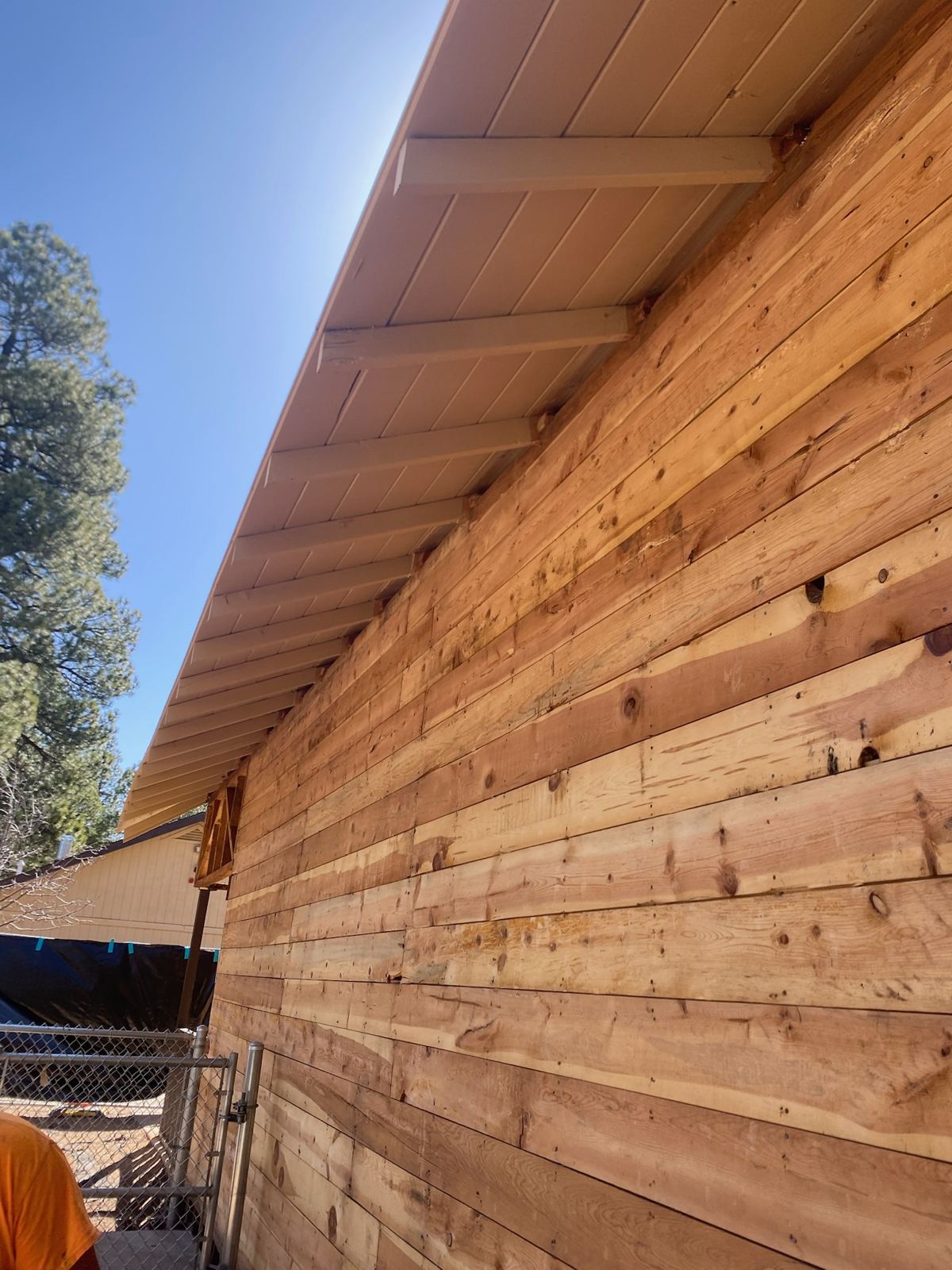 Old Maine Elementary exterior: new horizontal wood siding under the existing eave