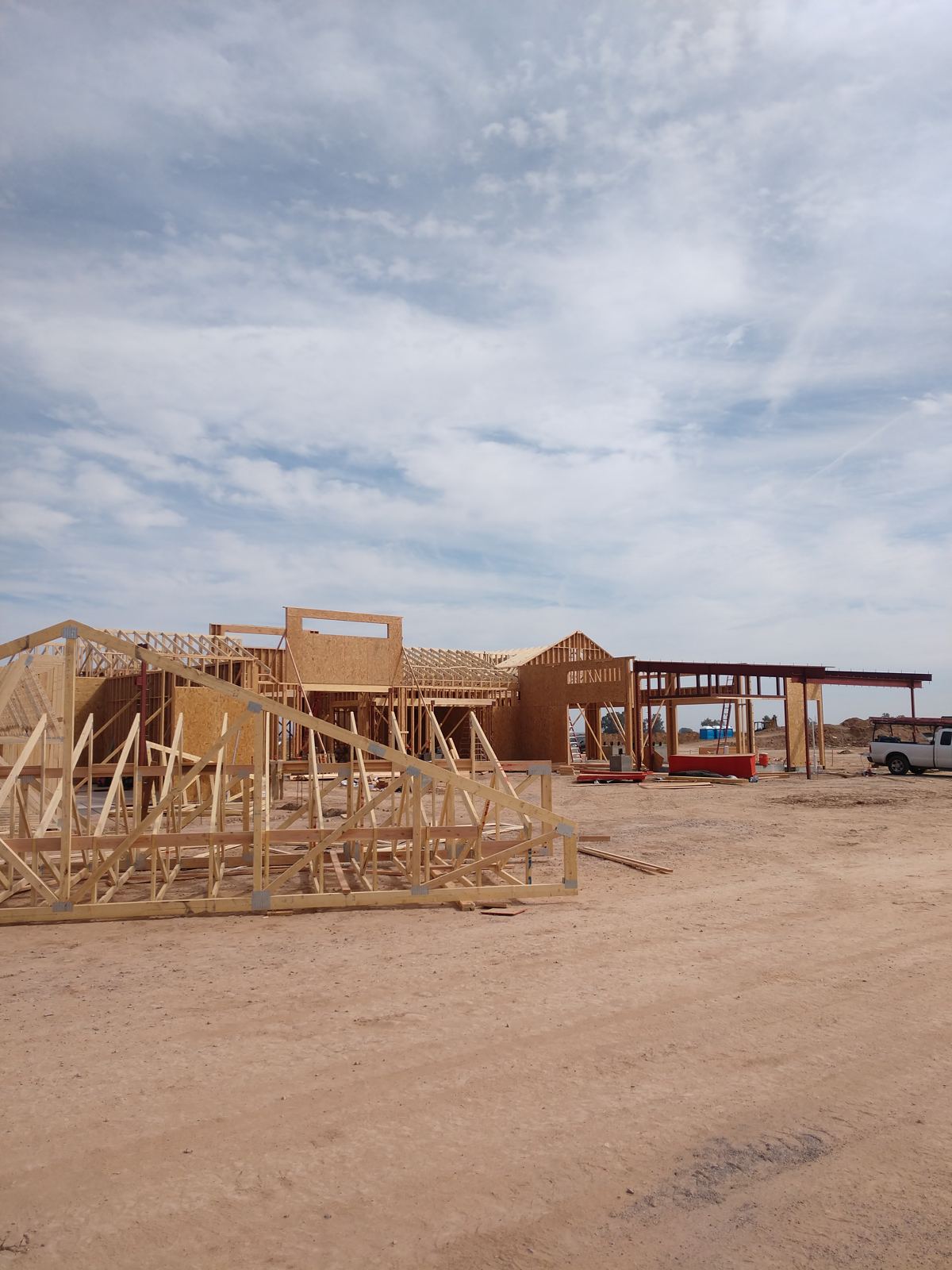 Prasada Country Club Main Building: stacked roof trusses in front of the wall framing and steel canopy