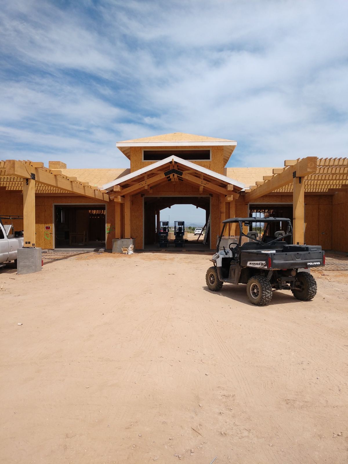 Prasada Country Club Main Building: sheathed entry with heavy timber gable, pergolas and cupola